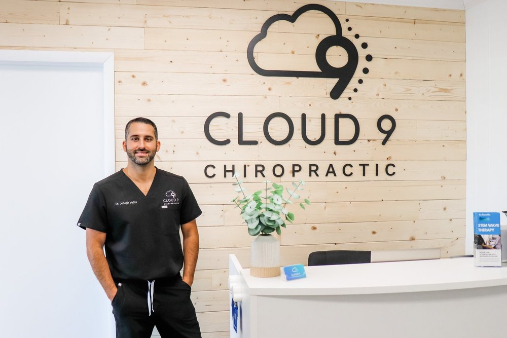 Dr. Joseph Veltre at the Cloud 9 Chiropractic reception desk